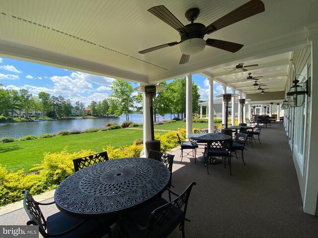 view of patio featuring a water view and ceiling fan