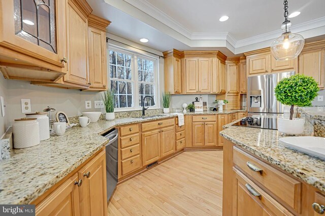 kitchen featuring pendant lighting, sink, light hardwood / wood-style flooring, appliances with stainless steel finishes, and light stone counters