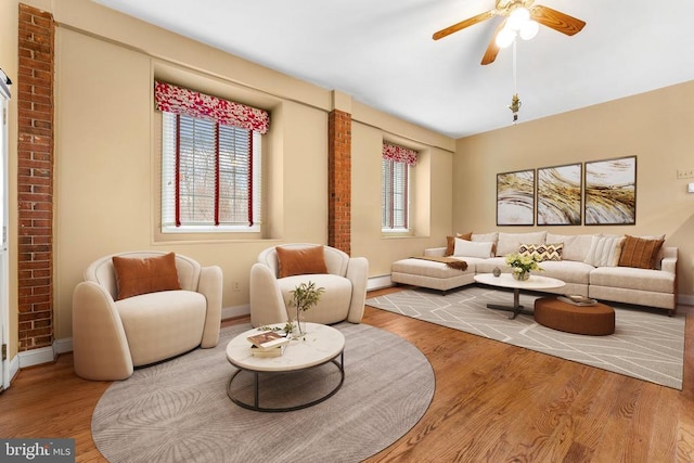 living room featuring hardwood / wood-style flooring, a baseboard radiator, and ceiling fan