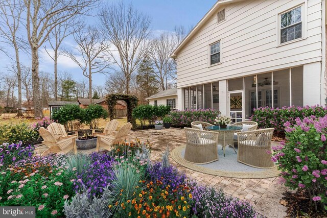 view of patio / terrace featuring ceiling fan and an outdoor fire pit