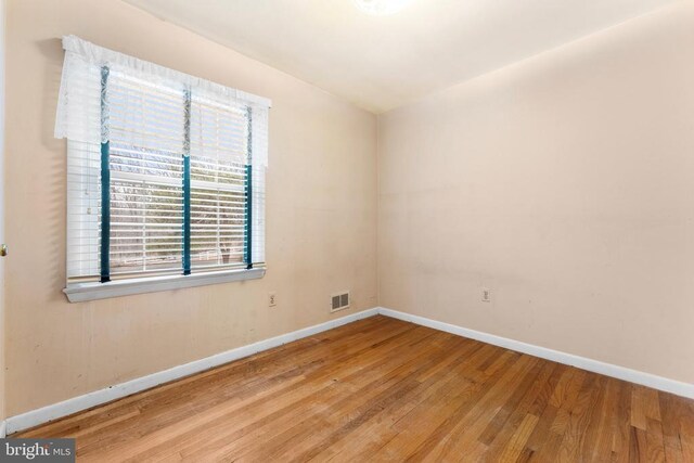 spare room featuring light hardwood / wood-style flooring