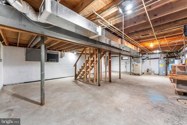 basement featuring heating unit and water heater