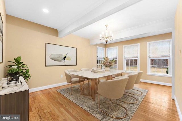 dining area with beamed ceiling, a chandelier, and light hardwood / wood-style floors