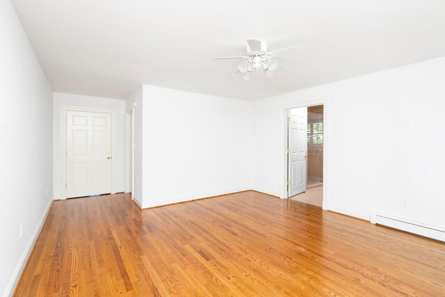 unfurnished room with ceiling fan, light hardwood / wood-style floors, and a baseboard radiator