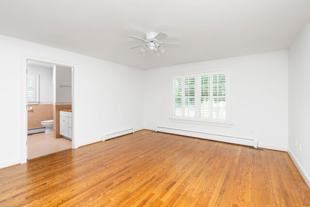 unfurnished room with light hardwood / wood-style flooring and a baseboard radiator