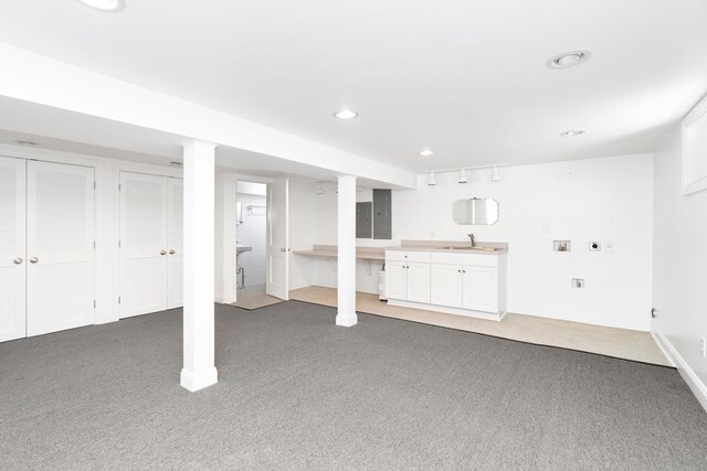 basement featuring sink and carpet