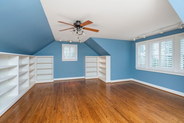 additional living space featuring hardwood / wood-style floors, vaulted ceiling, and ceiling fan