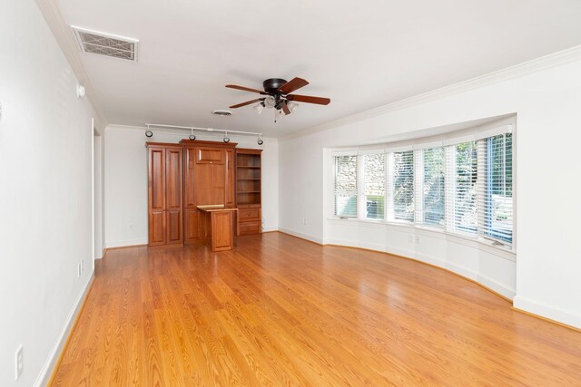 unfurnished living room featuring crown molding, rail lighting, ceiling fan, and light hardwood / wood-style floors