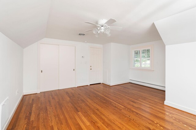 bonus room featuring a baseboard radiator, lofted ceiling, hardwood / wood-style floors, and ceiling fan