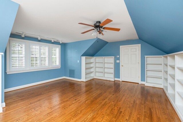 additional living space featuring ceiling fan, wood-type flooring, and vaulted ceiling