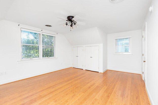 bonus room with ceiling fan, lofted ceiling, and light wood-type flooring