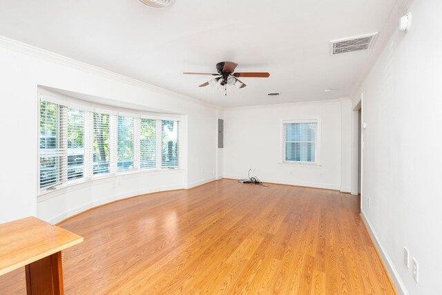 spare room featuring ornamental molding, ceiling fan, and light wood-type flooring