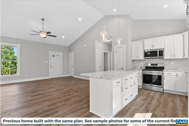 kitchen with white cabinetry, pendant lighting, stainless steel appliances, and a kitchen island