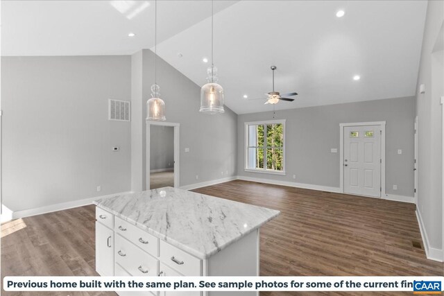 kitchen featuring dark hardwood / wood-style floors, high vaulted ceiling, white cabinetry, hanging light fixtures, and a center island