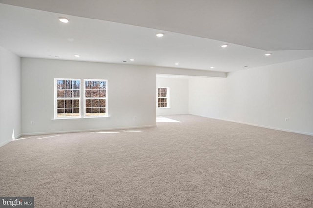 unfurnished room featuring recessed lighting, light carpet, and baseboards