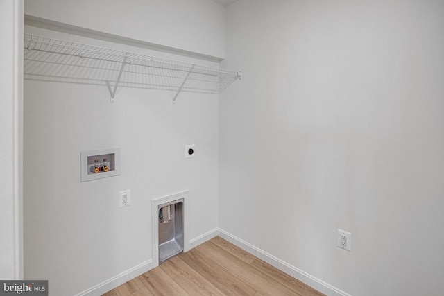 washroom featuring laundry area, baseboards, wood finished floors, hookup for a washing machine, and hookup for an electric dryer