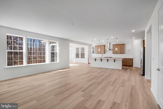 unfurnished living room with light wood finished floors and recessed lighting