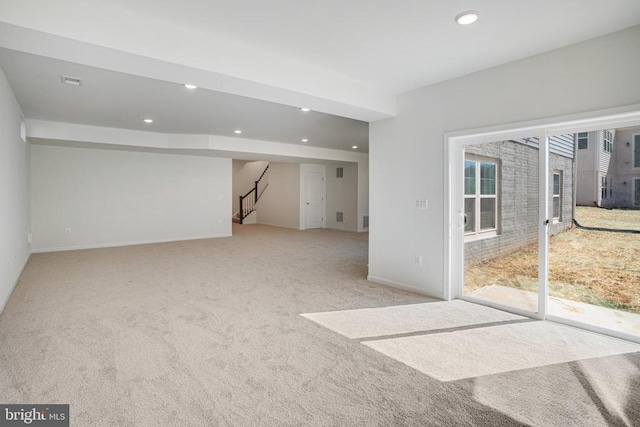 interior space with light carpet, baseboards, visible vents, stairway, and recessed lighting