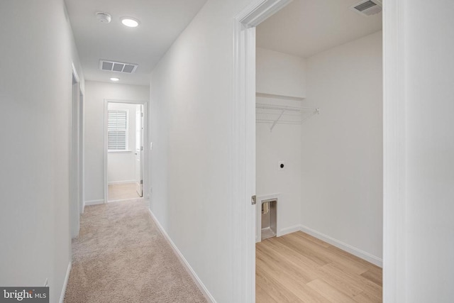 hall with baseboards and visible vents