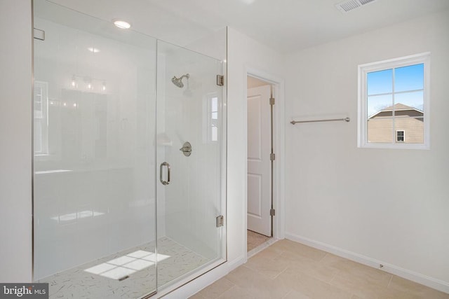 full bathroom featuring a stall shower, baseboards, visible vents, and tile patterned flooring