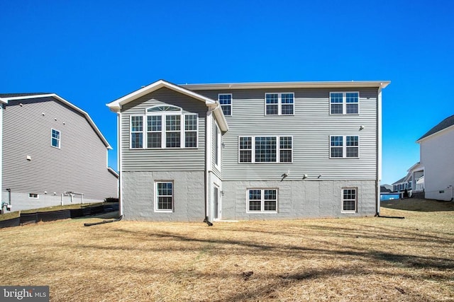 back of property featuring a lawn