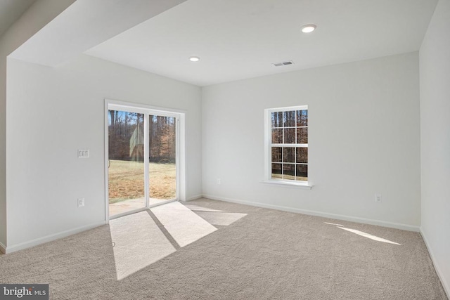 spare room with light carpet, baseboards, and recessed lighting