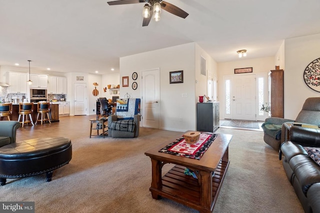 carpeted living room featuring ceiling fan