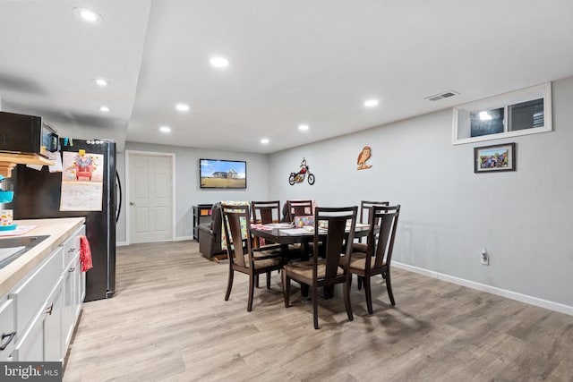 dining space featuring light hardwood / wood-style flooring