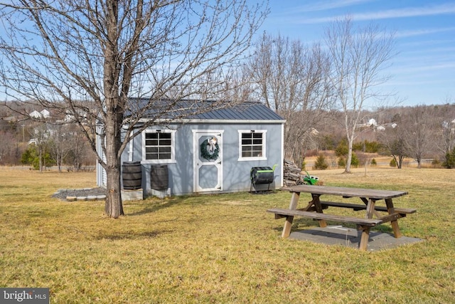 view of outbuilding with a lawn