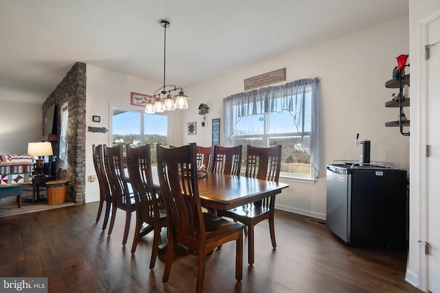 dining space with dark hardwood / wood-style floors