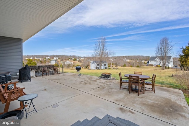 view of patio featuring a fire pit and a storage unit