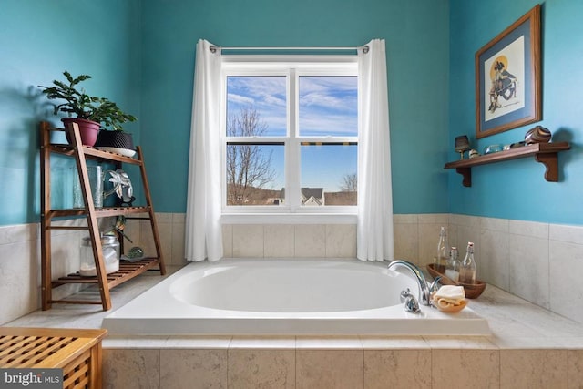 bathroom with a relaxing tiled tub