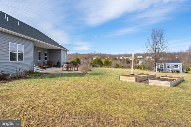 view of yard with an outdoor structure and a patio area