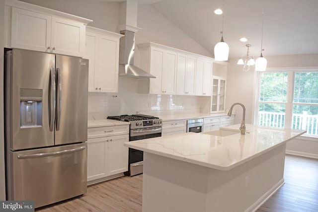 kitchen with light wood finished floors, white cabinetry, appliances with stainless steel finishes, and a sink