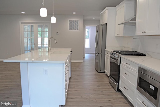 kitchen with light wood-style floors, white cabinetry, appliances with stainless steel finishes, and a sink