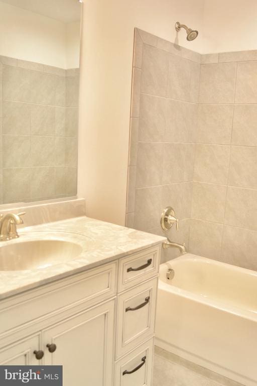 bathroom with  shower combination, tile patterned floors, and vanity