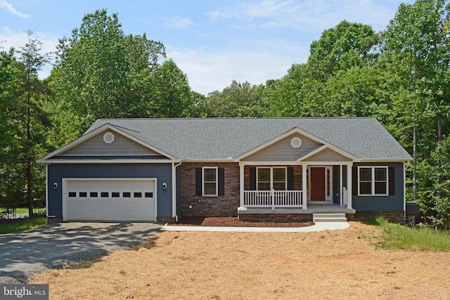 view of front of home featuring a garage, aphalt driveway, roof with shingles, and a porch