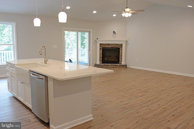 kitchen with recessed lighting, stainless steel dishwasher, light wood-style floors, open floor plan, and white cabinetry