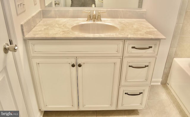 full bathroom with vanity, a bath, and tile patterned floors