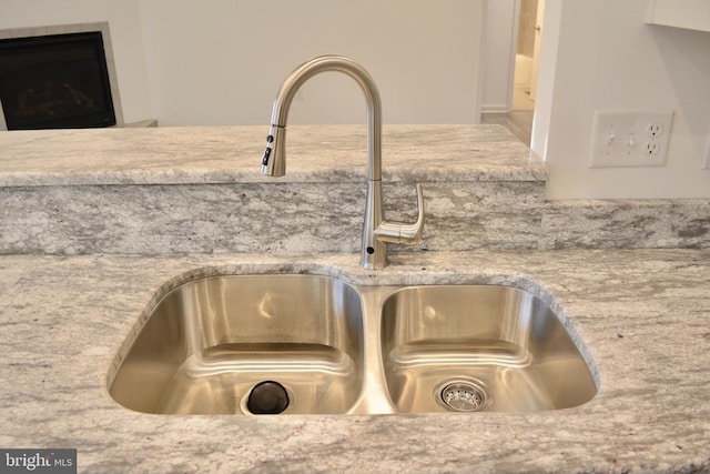 details with light stone counters and a sink