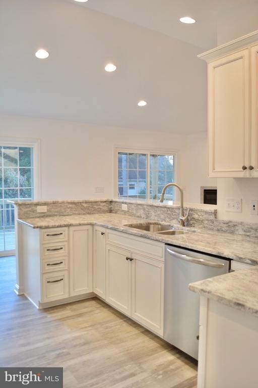 kitchen with dishwasher, a peninsula, a sink, and a wealth of natural light