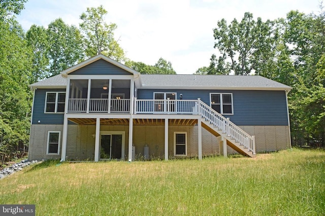 back of house featuring a deck, brick siding, stairway, and a sunroom