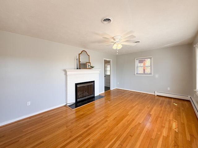 unfurnished living room featuring a ceiling fan, baseboards, visible vents, light wood-style flooring, and a fireplace with flush hearth