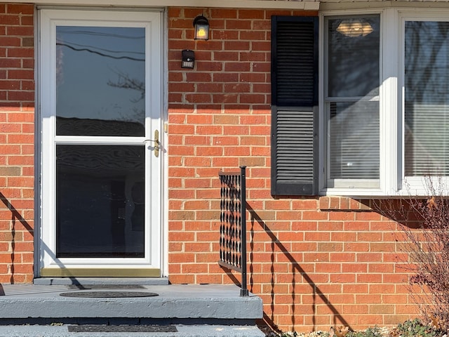 property entrance with brick siding