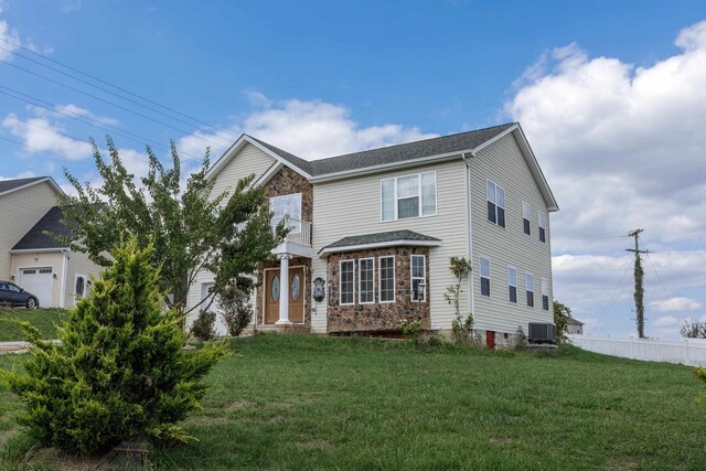 view of front of house featuring cooling unit and a front yard