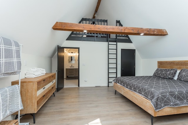 bedroom with lofted ceiling with beams and wood finished floors