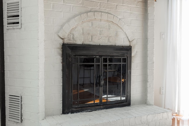 details with a brick fireplace