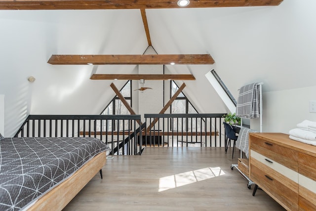 bedroom featuring vaulted ceiling with skylight and wood finished floors