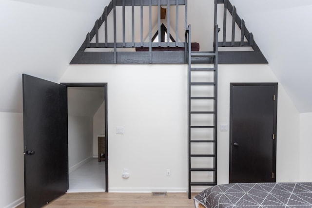 unfurnished bedroom featuring baseboards, visible vents, and wood finished floors