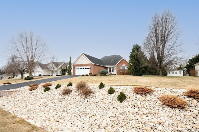 view of front of house featuring a garage and a front yard